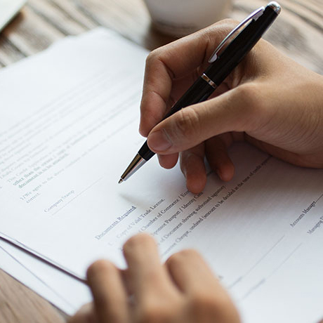 A person is signing a document.