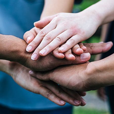 People stacking hand together.
