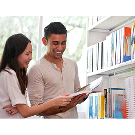 Two students in library.