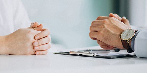 Two person with folded hands.